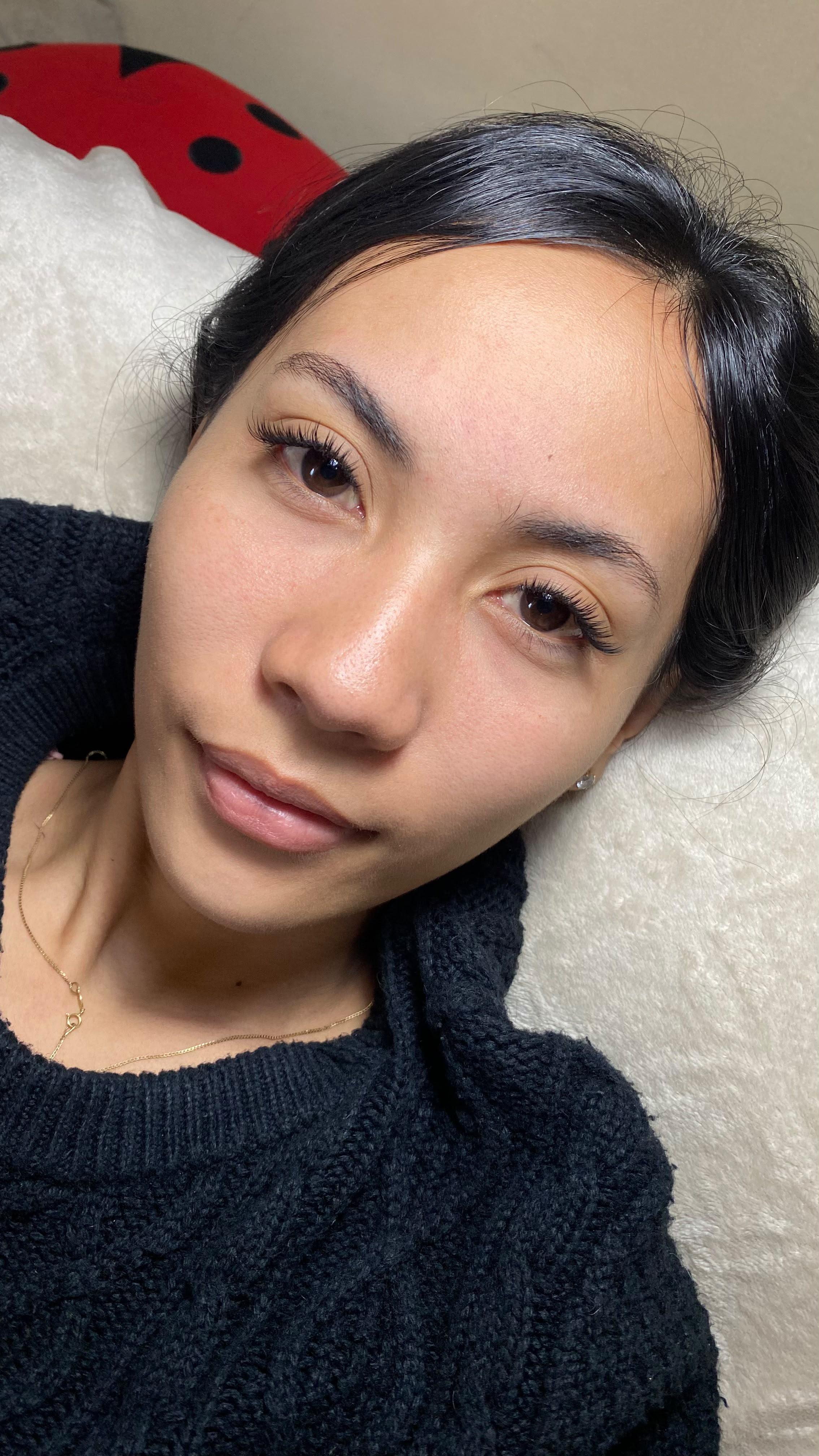 Natural eyelash extension result on a dark-haired client