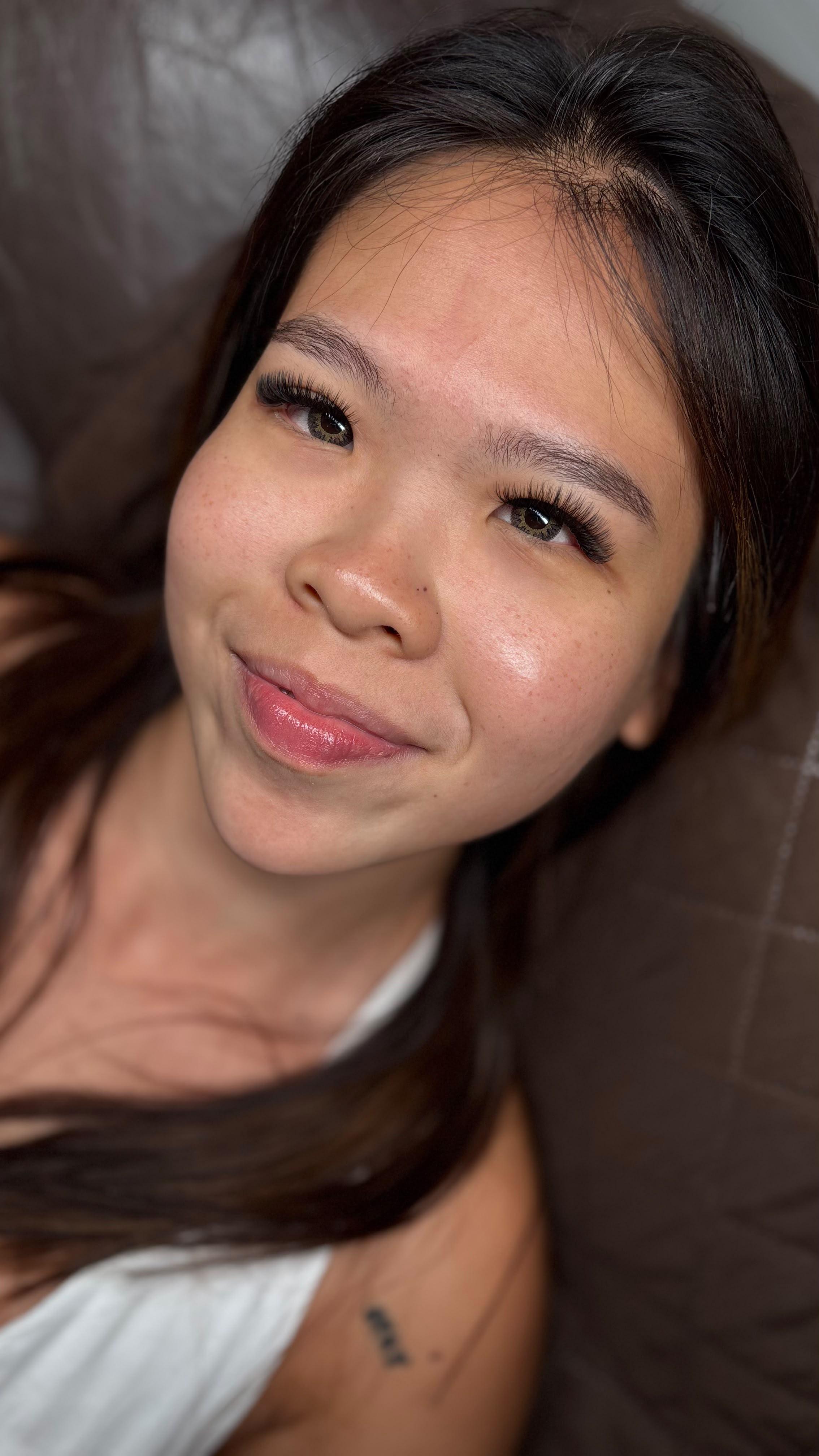 Soft Volume eyelash extensions on a smiling client